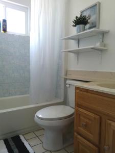 a bathroom with a white toilet and a sink at Pasadena single house in Pasadena