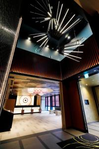 a large room with a large room with a ceiling with lights at Daiwa Roynet Hotel KANAZAWA-MIYABI in Kanazawa