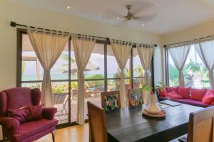 a living room with a table and a view of the ocean at Jambiani Villas in Jambiani