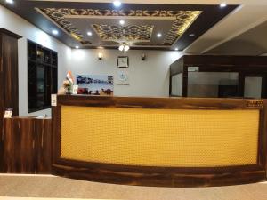 a lobby of a restaurant with a yellow bar at Hotel Pushkar Legacy in Pushkar