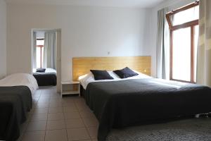En eller flere senger på et rom på Hotel De Loft