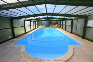 a large swimming pool in a building at Locatlantique in Aytré