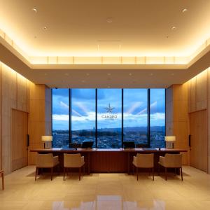 a large waiting room with a large window at Candeo Hotels Osaka Kishibe in Suita
