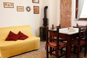 a living room with a couch and a table and a chair at The Nest in Grosseto