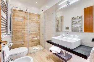 a bathroom with a white sink and a shower at Romoli Hotel in Rome