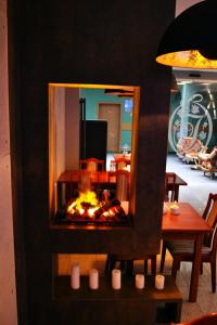 a fire place in a living room with a table at Hotel Julian in Szczecin