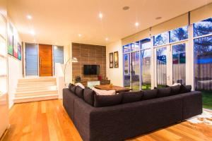 a living room with a couch and a tv at Arthouse, beach 200m, kids TV area, air-con in Dunsborough