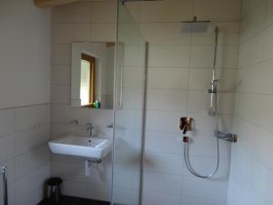 a bathroom with a sink and a shower at Haus Sageler in Tux