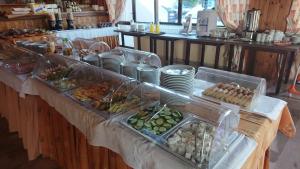 a buffet line with plates and food on a table at Poseidon Hotel in Amoudara Herakliou