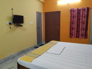 Tempat tidur dalam kamar di Bhalobasa Anandabas
