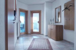 a room with a hallway with a door and a rug at Ferienwohnung Rheinblick Bislich in Wesel