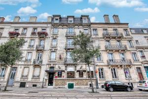 a large building with a car parked in front of it at Cit'Hotel La Résidence in Nancy