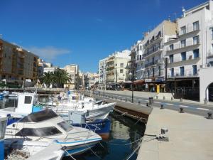 a group of boats docked in a harbor with buildings at Cassa Jessi in Tarragona