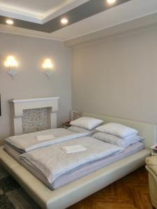 a bedroom with two beds and a fireplace at Central in Zalaegerszeg