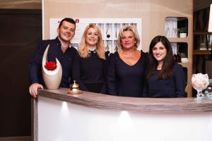 a group of people standing behind a counter at Cit'Hotel La Résidence in Nancy