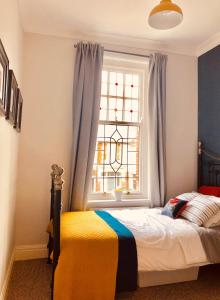 a bedroom with a bed and a window at Sea Retreats, Whitley Bay, Sleeps 9 in Whitley Bay