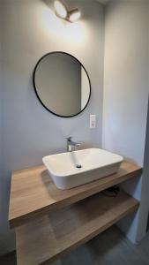 a bathroom sink with a mirror on the wall at Jacob´s Apartement in Pilsen