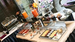 a buffet line with food on a table at La Place Boutique Hotel in Antibes