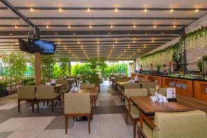 a restaurant with wooden tables and chairs and a bar at Land Park Hotel in Istanbul