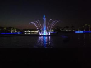 a fountain in the middle of the water at night at The Blyde Riverwalk Estate in Pretoria