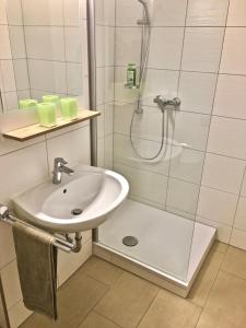 a bathroom with a sink and a shower at Ferienwohnung Asal in Waldbronn