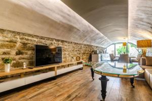 a living room with a stone wall at Villa Gabriela in Korčula