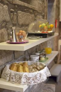 a shelf with a tray of pastries and other foods at Being Porto Hostel in Porto