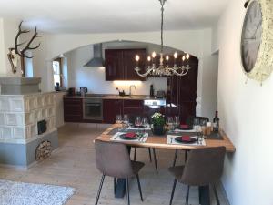 a kitchen with a table with chairs and a dining room at Apartment Streifblick in Reith bei Kitzbühel