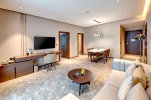 a living room with a couch and a table at Millennium Place Barsha Heights Hotel in Dubai