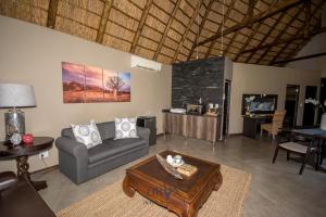 a living room with a couch and a table at Oryx B&B Reserved Guests Only in Mokopane