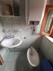 a bathroom with a sink and a toilet at Guest House Accommodation Rupine in Premantura +92 photos