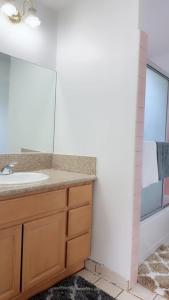 a bathroom with a sink and a mirror at Pasadena master room in Pasadena