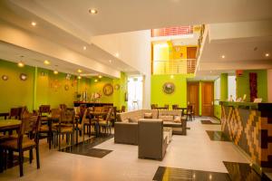 a restaurant with green walls and a couch and chairs at Hotel Incamin Mirador in Arequipa