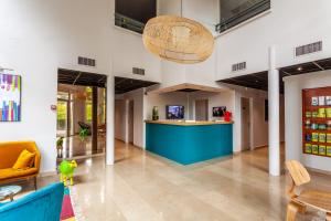 a lobby with a blue island in a building at Hôtel Full Colors in Craponne