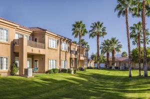 a large house with palm trees in the yard at WorldMark Cathedral City in Cathedral City