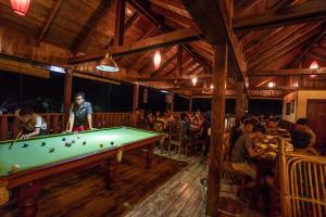 a pool table in a restaurant with a group of people at Ratanakiri Paradise Hotel & Restaurant in Banlung