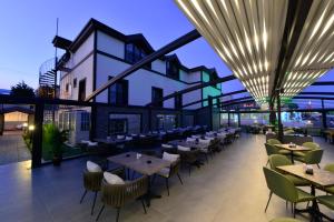 a restaurant with tables and chairs on a roof at Room 23 Hotel in Akçay