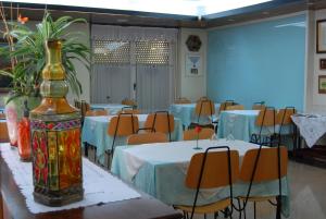 a room with tables and chairs and a room with tables and chairs at Hostal Victor in Oliana