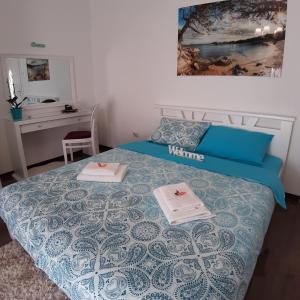 a bedroom with a bed with two plates on it at Apartment Zorana-Center in Novi Sad