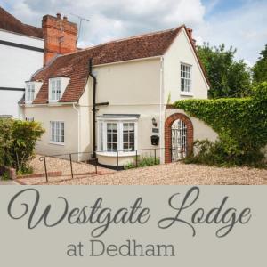 a white house with the words westgate cottage at becham at Westgate Lodge at Dedham in Dedham