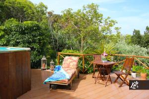a patio with a table and chairs on a deck at Quinta do Paraíso in Porto Martins