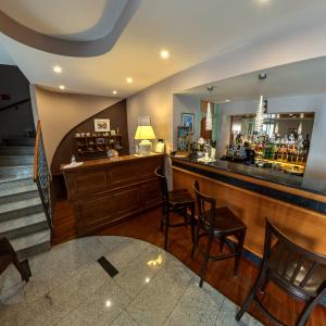 a bar with chairs and a counter with a mirror at Hotel Nostromo in Rabac