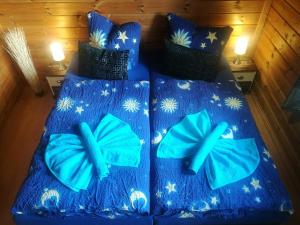 a bed with blue sheets with butterflies on it at Ferienwohnung“puutalossa“ in Sehlen