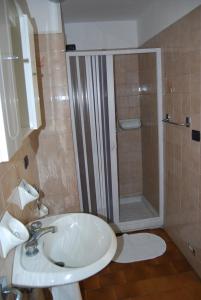 a bathroom with a sink and a shower at Albergo della Posta in Trivero