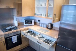 a kitchen with a stove and a refrigerator at Appleby Darlington in Darlington