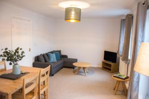 a living room with a couch and a table at Appleby Darlington in Darlington