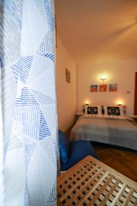 a room with two beds and a blue chair at June Studio in Braşov