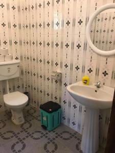 a bathroom with a toilet and a sink at The Gunjur Project Lodge in Gunjur