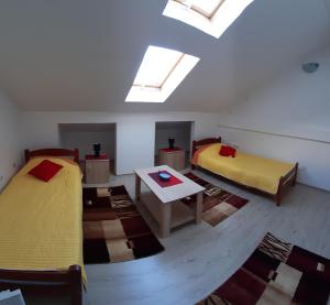 a room with two beds and a skylight at BC Apartments in Niš