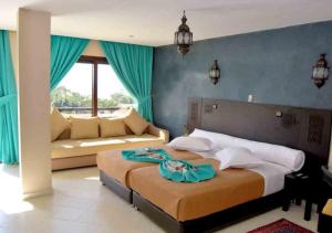 A bed or beds in a room at Suite Hotel Tilila